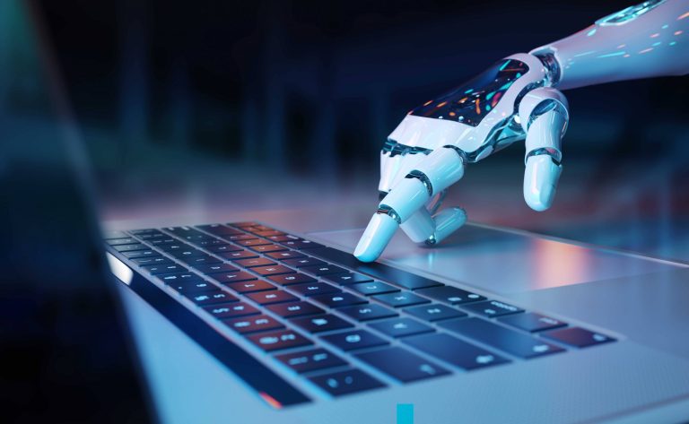 A close-up of a white robotic hand reaching down to press a key on a laptop keyboard, lit in blue tones