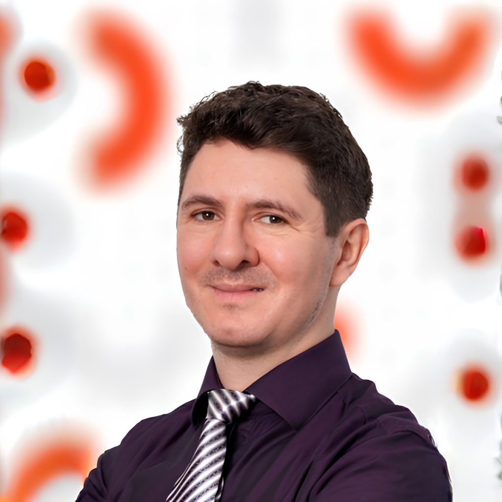 Portrait of Horea Soanca, Principal Sales Engineer for Test Cloud at UiPath, wearing a dark shirt and striped tie.
